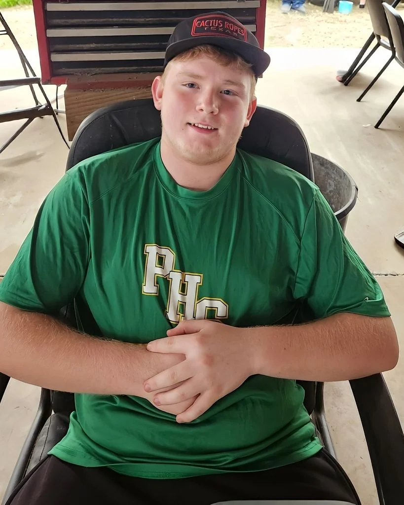 Matt Ray seated wearing a green shirt and black cap