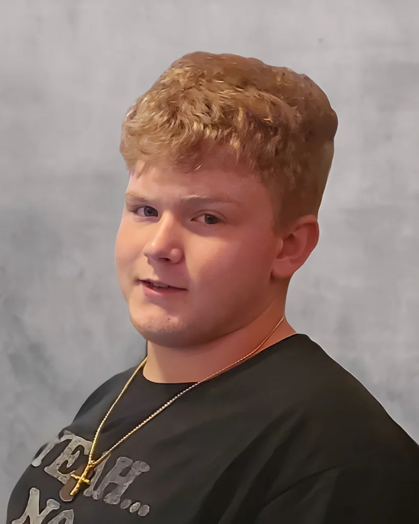 Portrait of Matthew David Matt Ray in a black shirt with a cross necklace